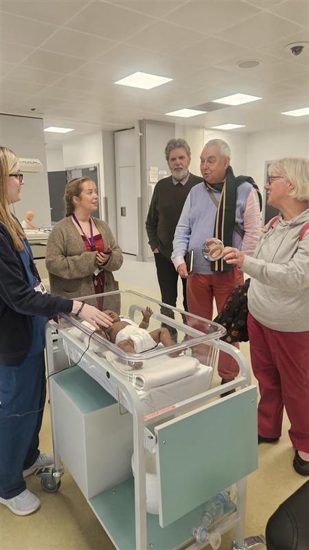 Phil Logan alumni group in the clinical skills teaching space