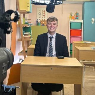 Joshua Geary sat behind a school desk