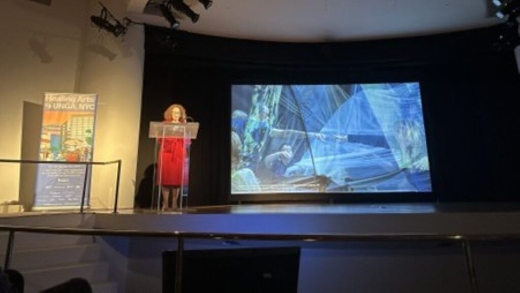 woman on stage at NYC healing conference