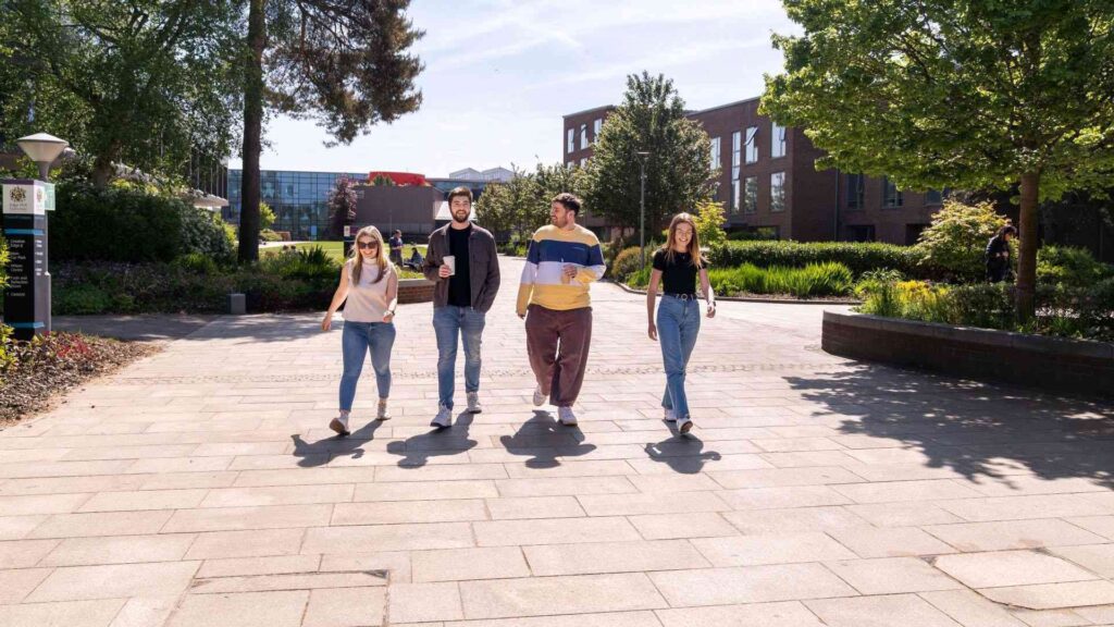 Postgraduate students walking through campus at Edge Hill