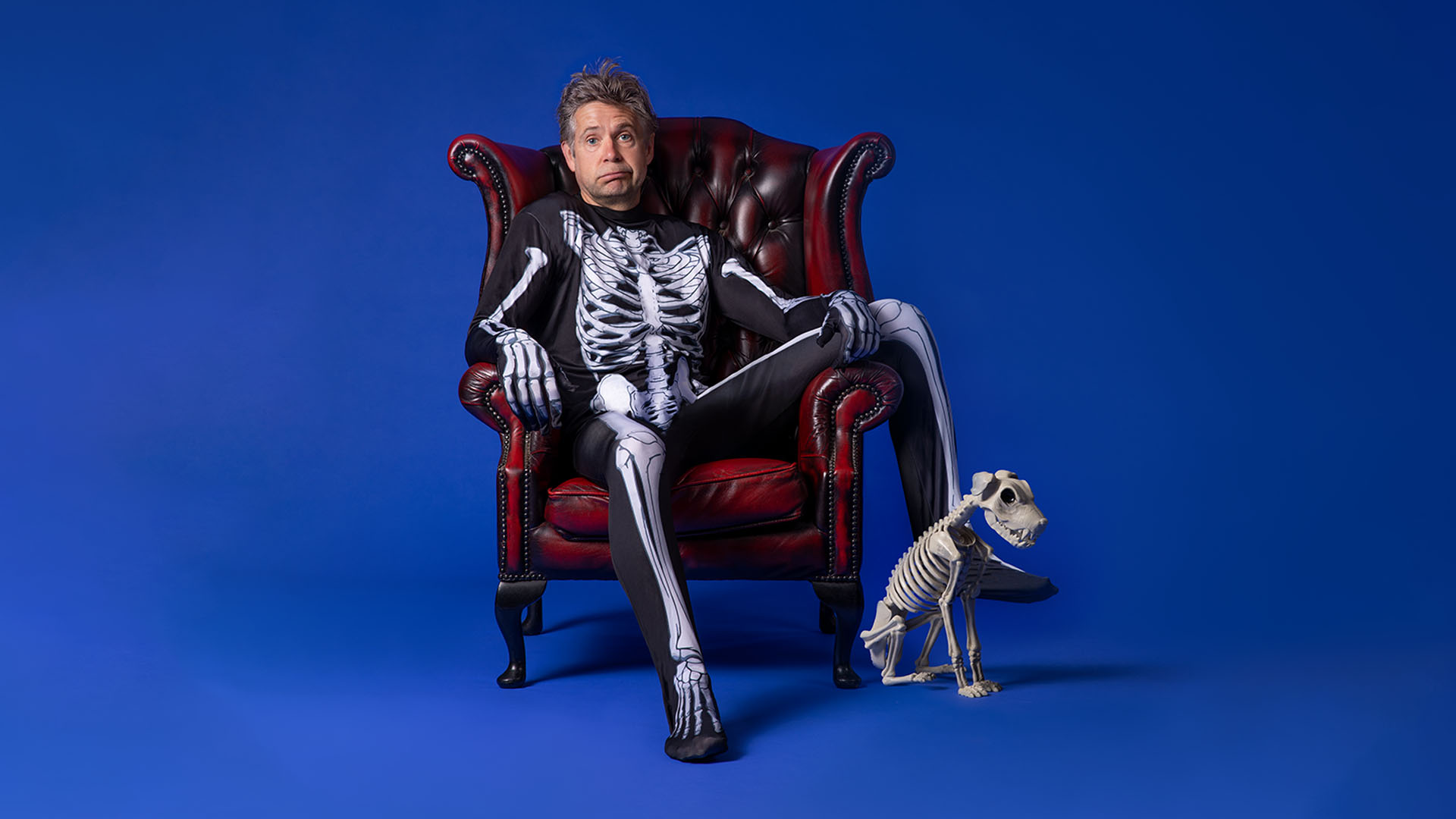 Picture of comedian Rob Rouse in skeleton costume with skeleton dog
