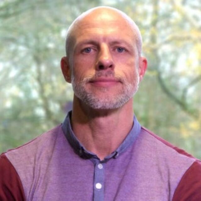 Professor Stuart Fairclough smiles at the camera.