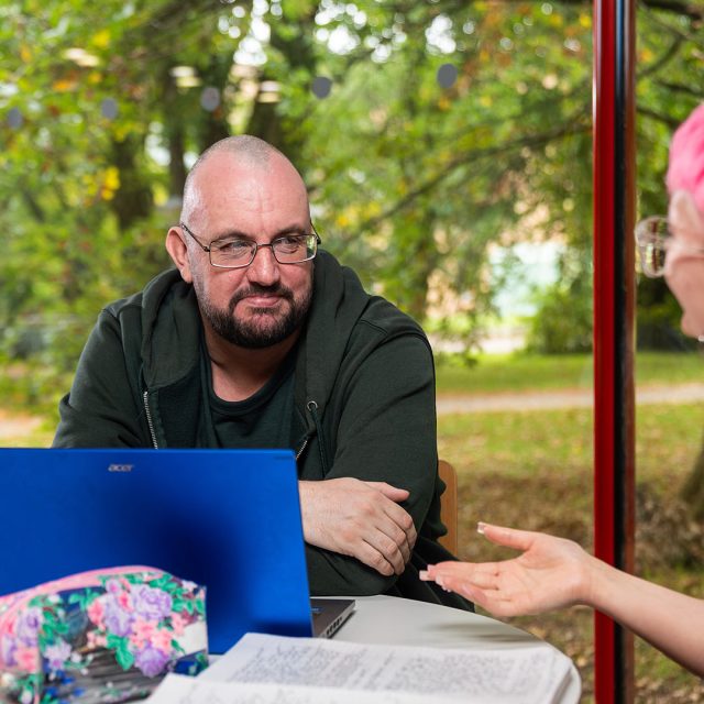Daniel Murphy profile photo, sat at a desk with a laptop