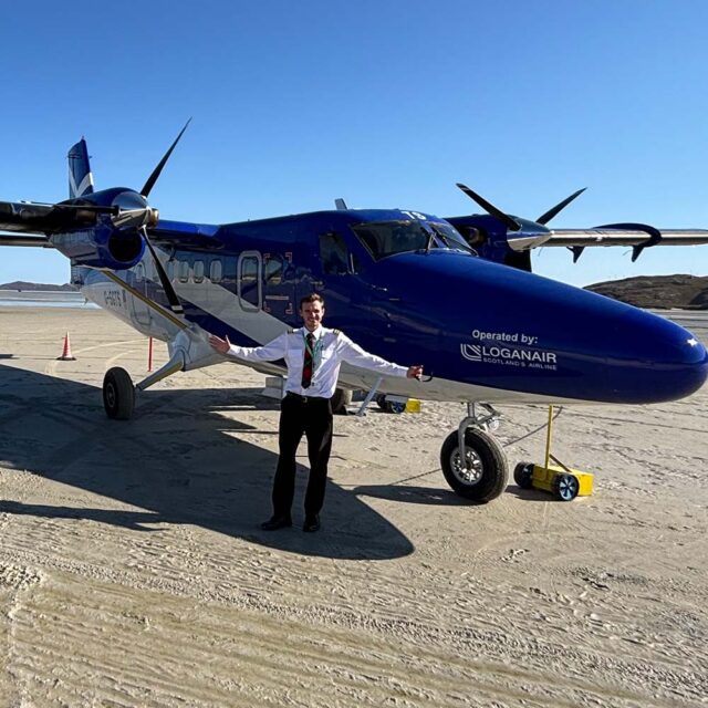 Graduate Joe Barrass standing with one of the airplanes that he helps crew