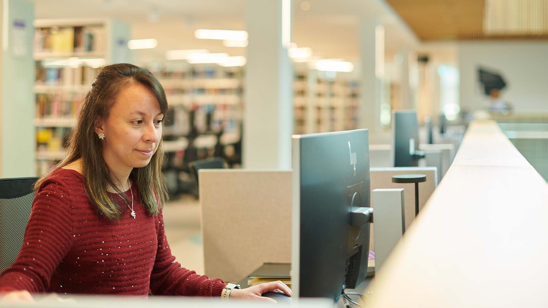 Postgraduate student at computer in the Catalyst building