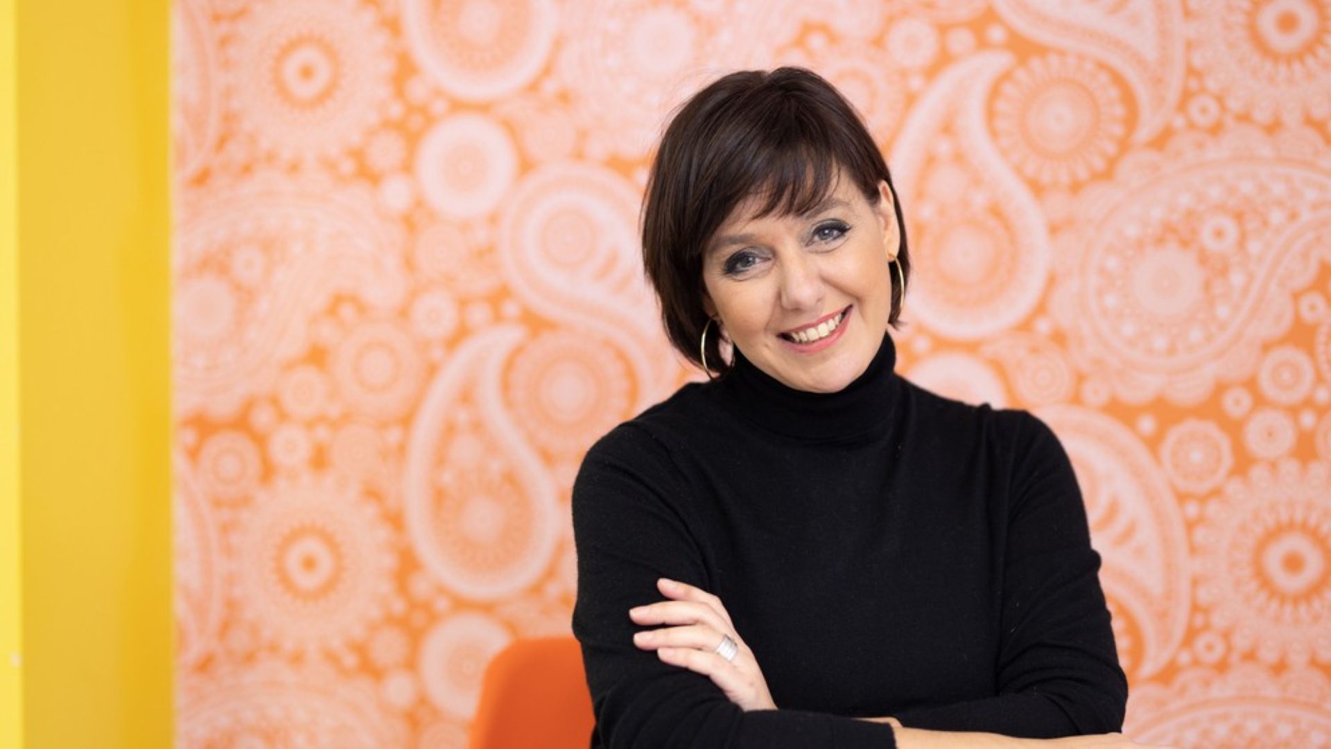 Angela smiles at the camera