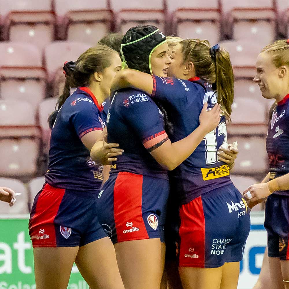 Beri Salihi is congratulated by team-mates playing for St Helens RLFC.