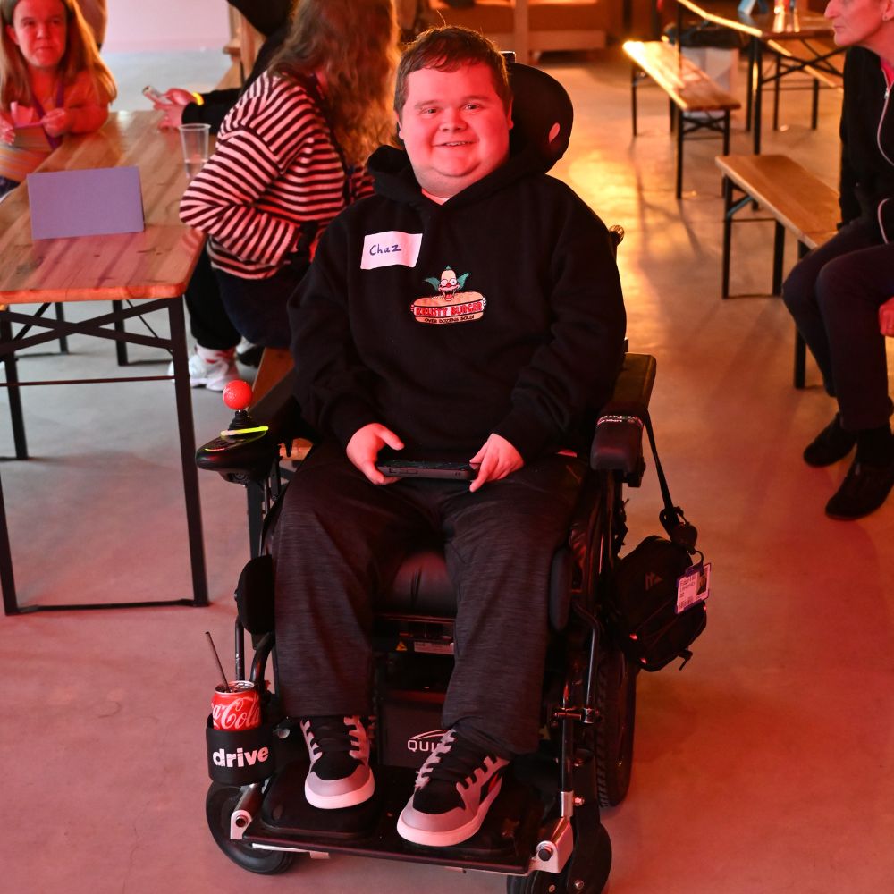 Charlie Wilson in his wheelchair looking straight at the camera smilling