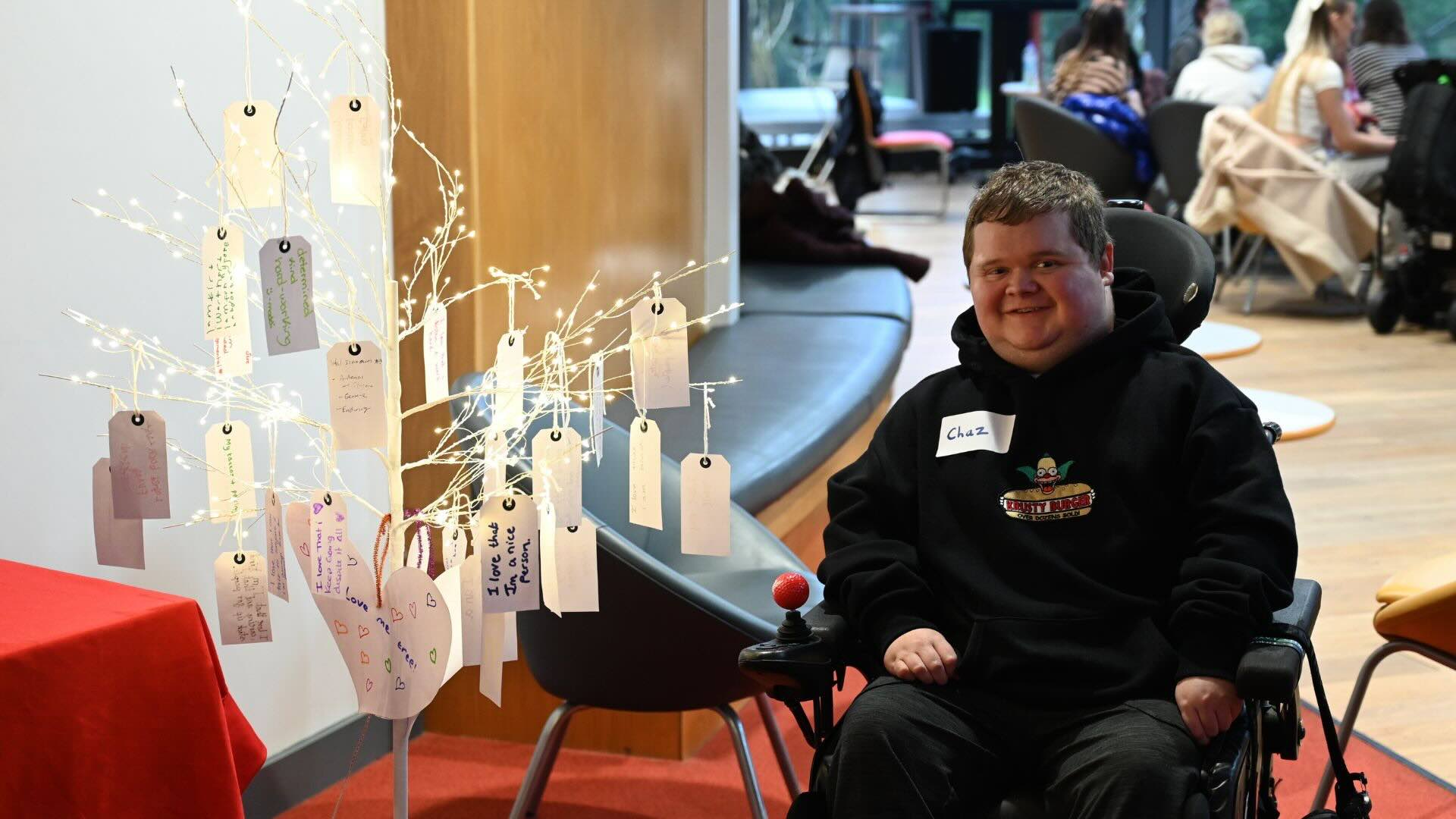 Charlie Wilson in his wheelchair looking straight at the camera smilling