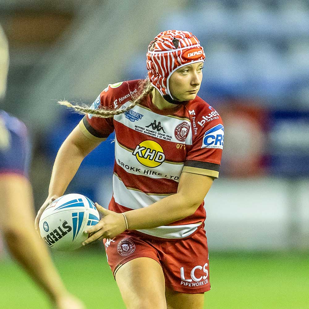 Izzy Rowe makes a pass playing for Wigan Warriors RLFC