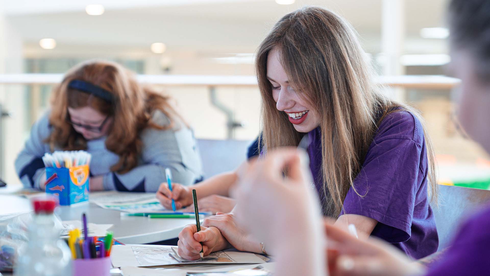 campus connector with students at a student life event doing crafts