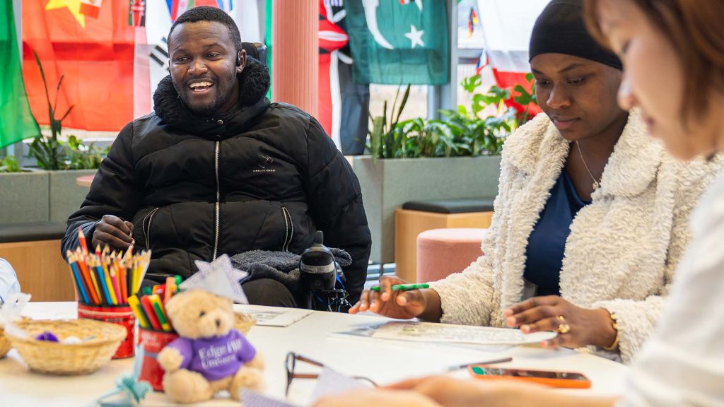 students sat in the hub attending a student life global cafe event