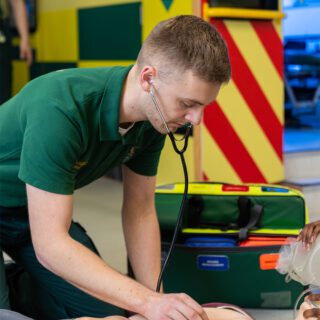 Paramedic student attends to a patient.
