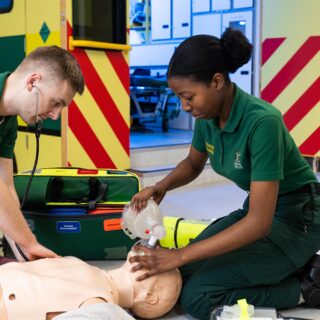 Paramedic Students practice resuscitation skills on a mannequin.