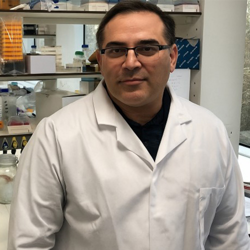 Aris Tagalakis wearing a lab coat in a science lab.