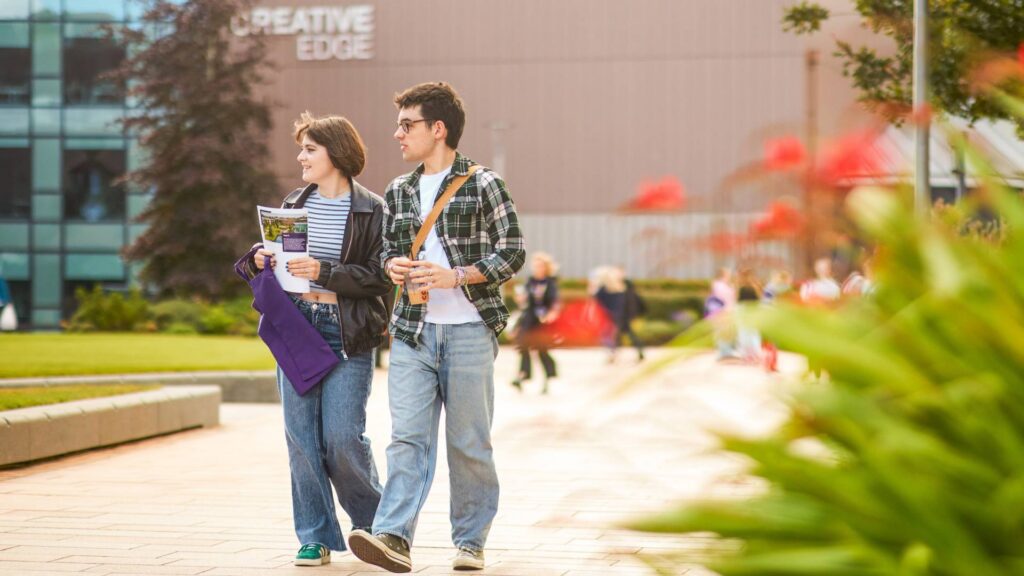 Students walk side by side through campus.