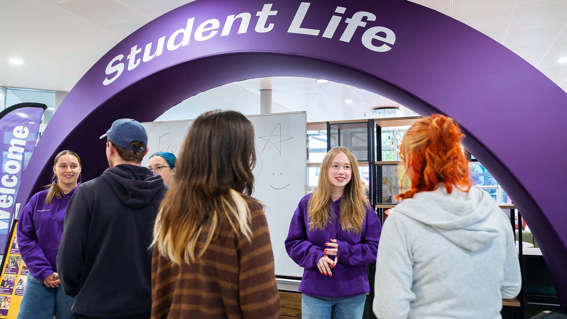students at the student life arch in the hub with campus connectors