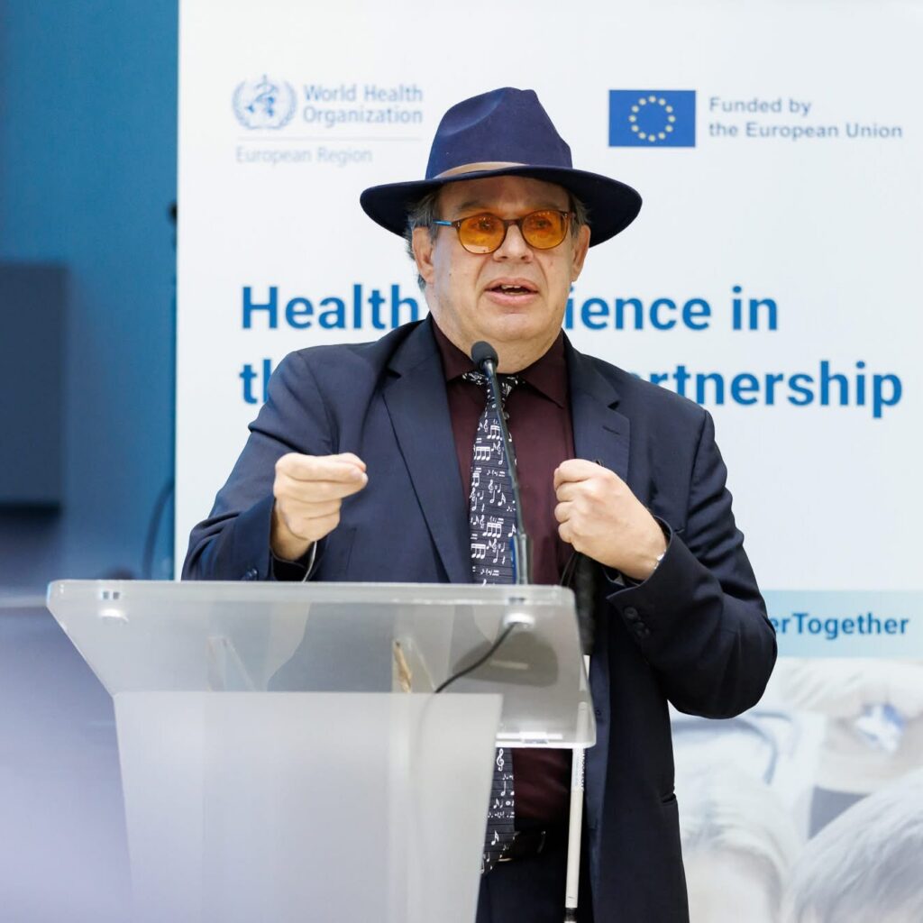 a photograph of Christopher Bailey presenting on stage