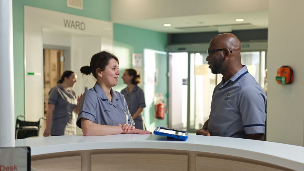 Nursing student on a ward having a conversation.