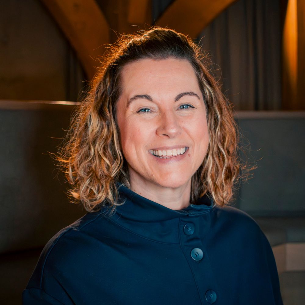 portrait of Lisa Allen, smilling and looking at the camera, wearing blue shirt.