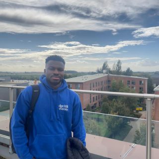 Profile photo of Martin Traore stood on a roof garden on Edge Hill campus