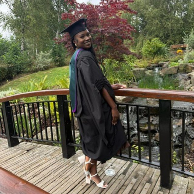 Merveille Mpulu in her graduation gown and cap