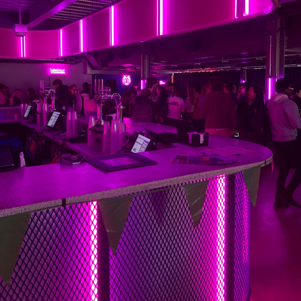 A group of students and staff gather together in a classroom