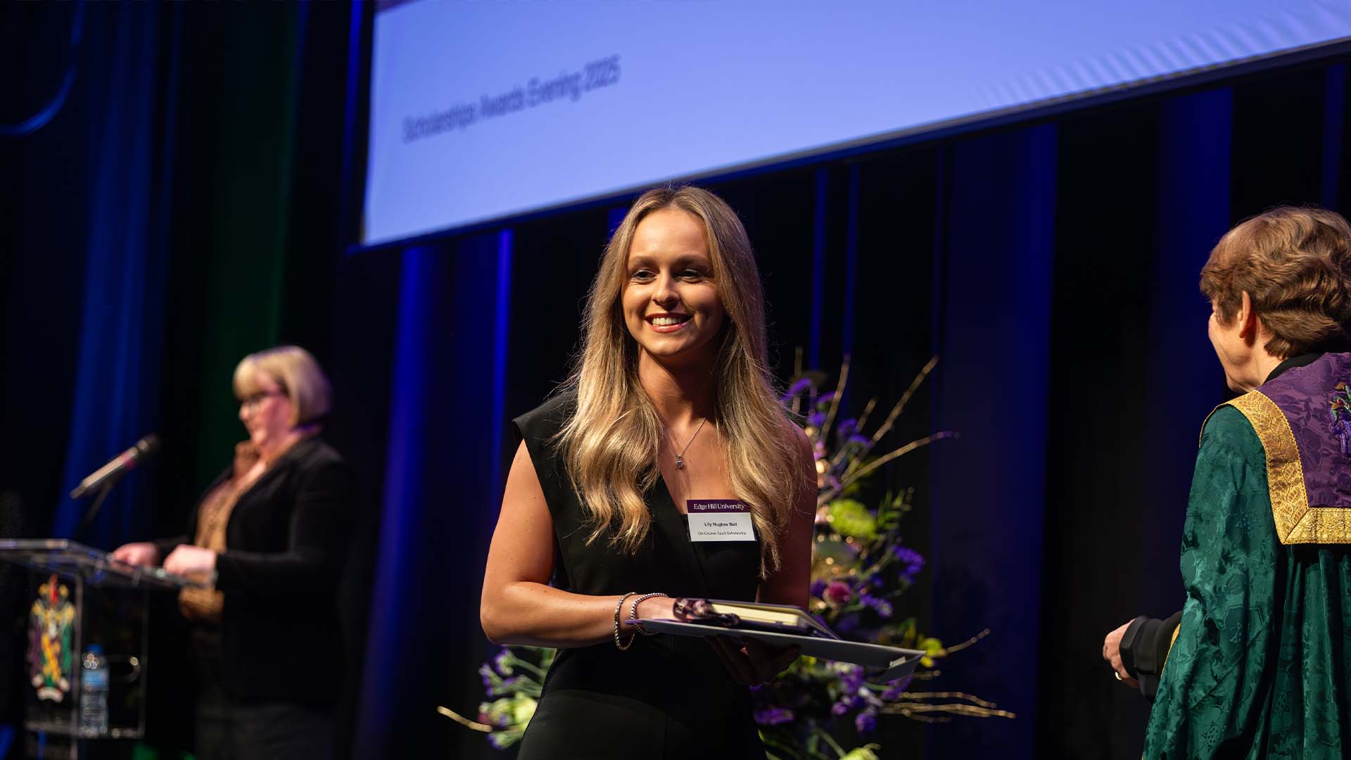 female student receiving her scholarship award