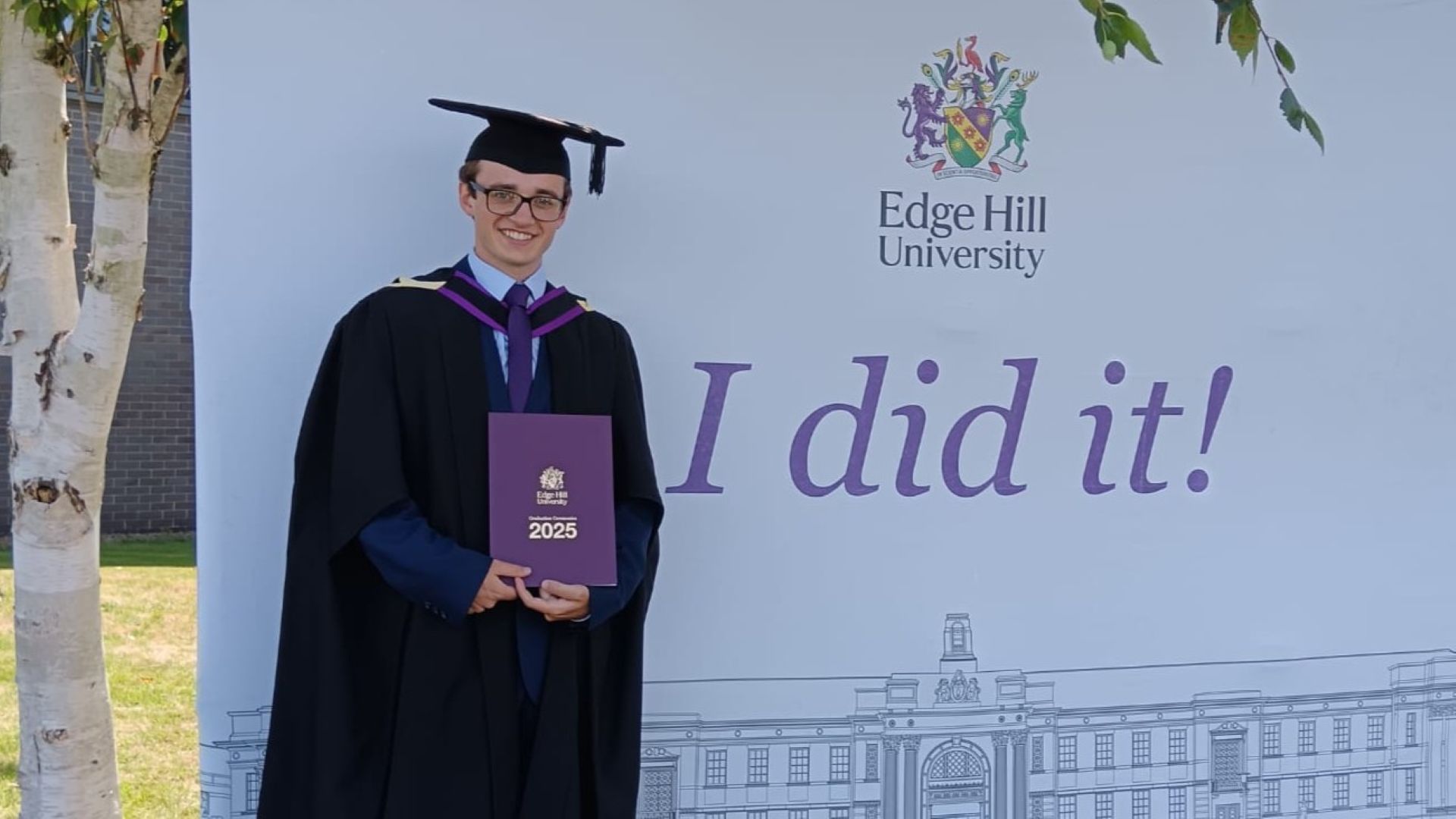 Alumnus Dylan Kane in graduation robes