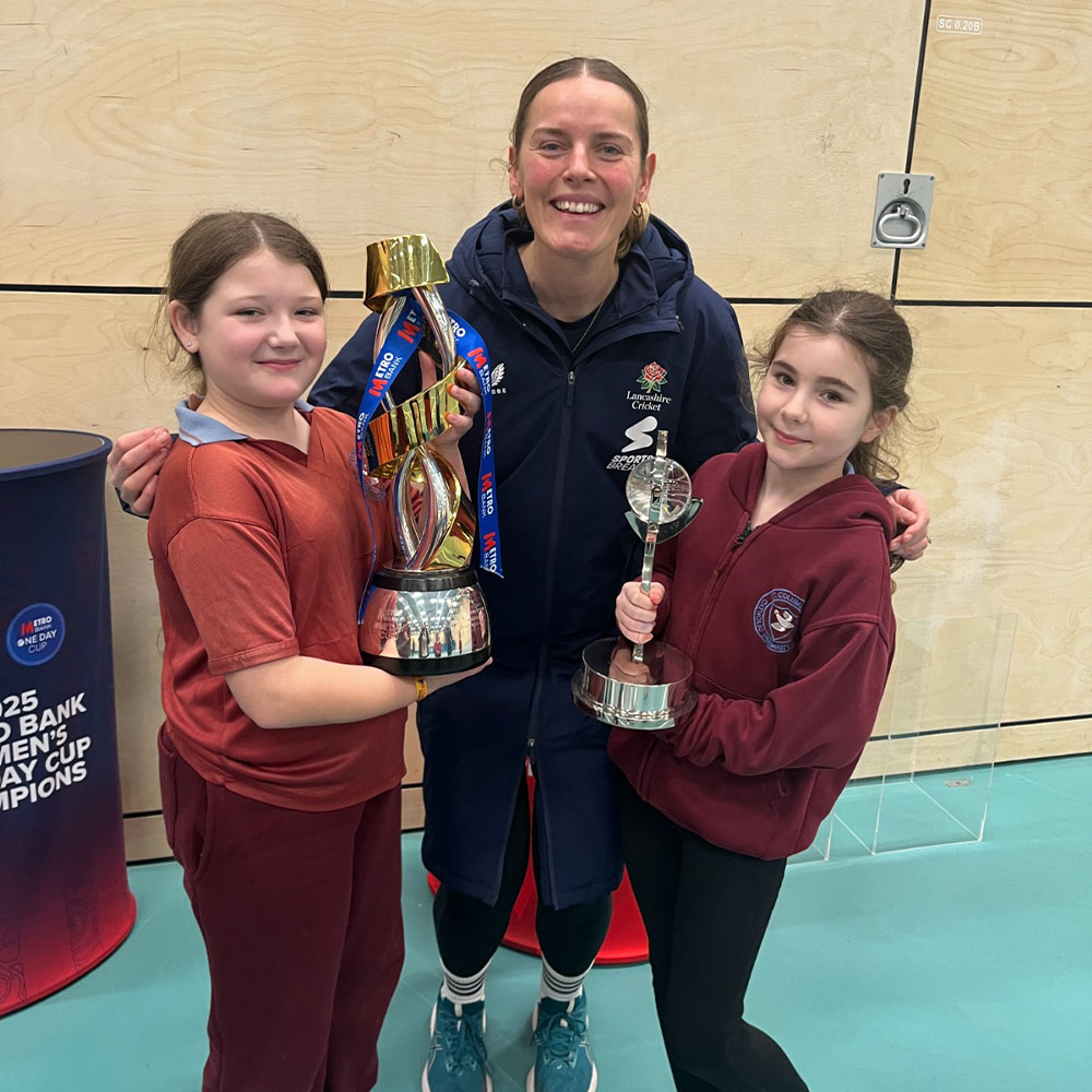 Lancashire Cricket Foundation’s Girls into the Game participants show off their trophies with one of their coaches