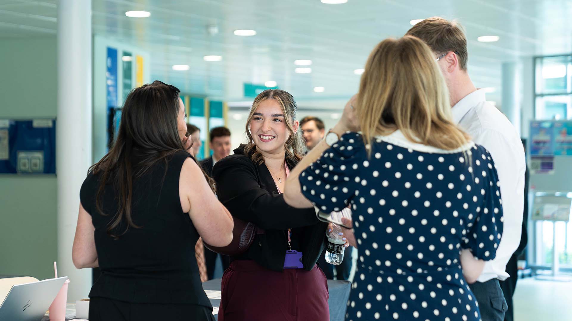 EHU staff talking at an on-campus event