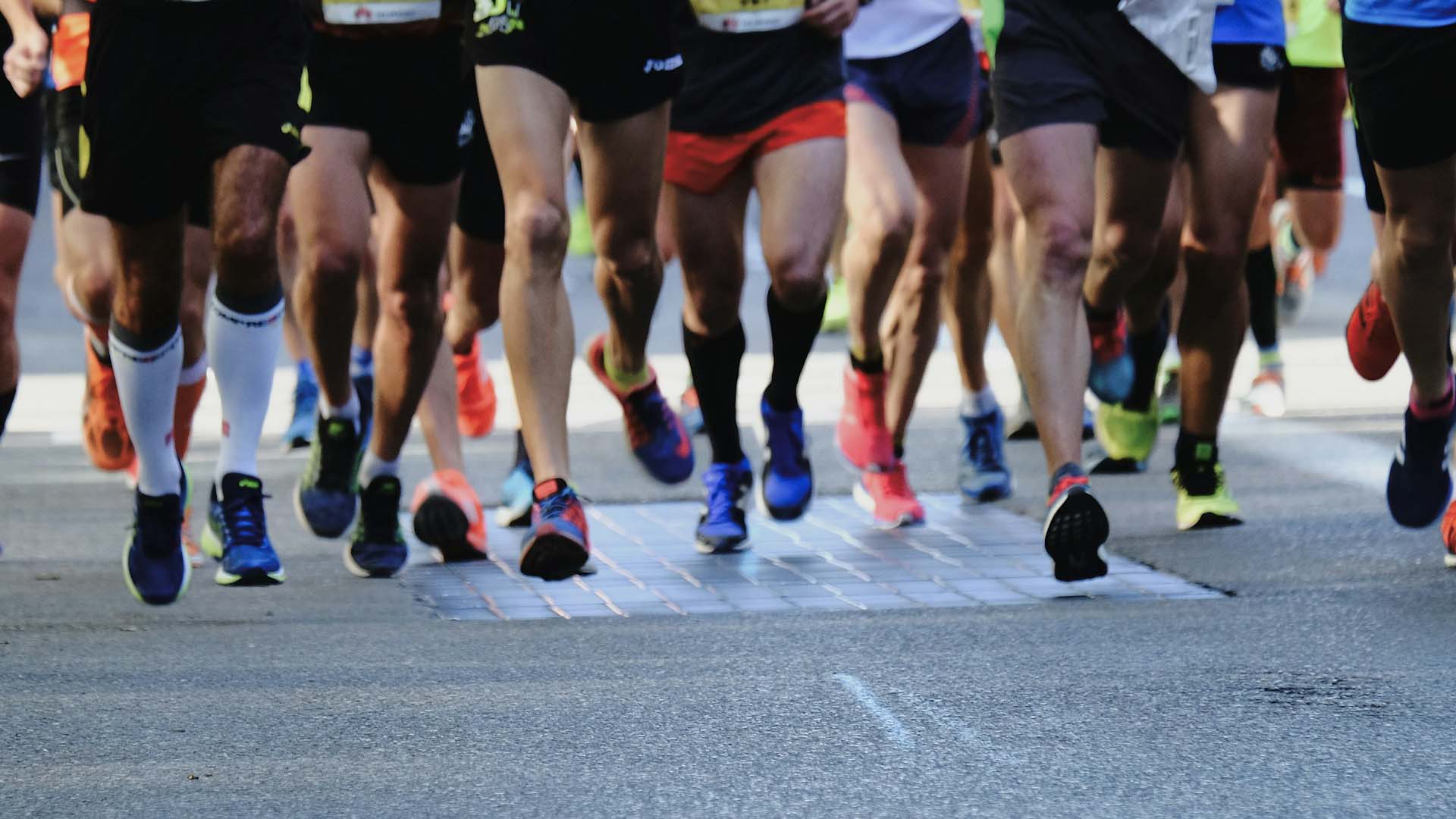 A photo of the legs of runners competing in a marathon