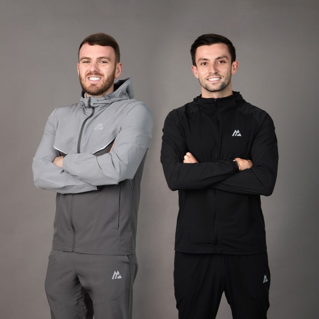 Kieran Riddell-Austin and Daniel Yuen stand side by side with their arms crossed.