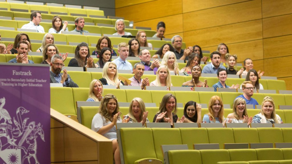 Group of fast track students sat in lecture theatre