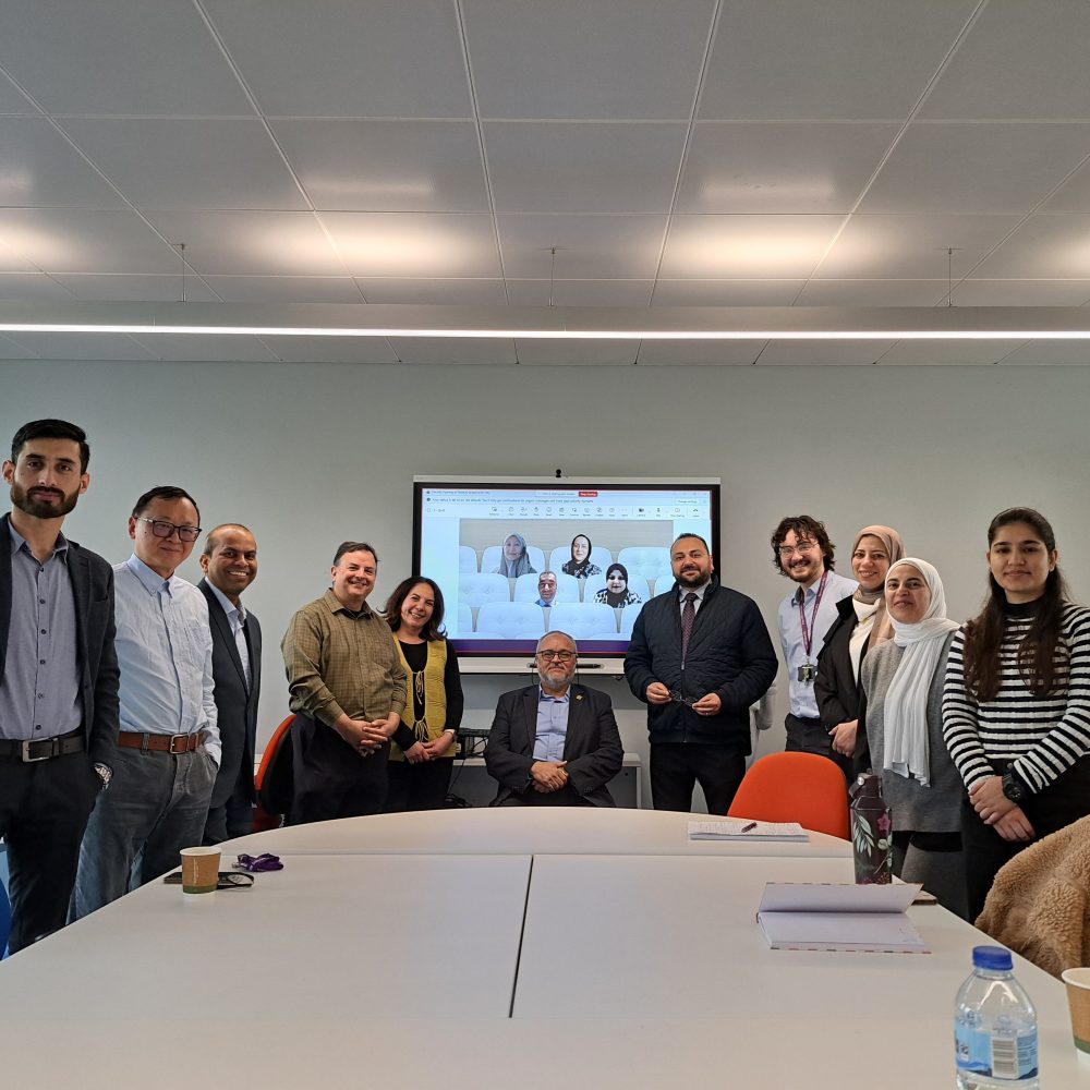 team of people standing in front of screen