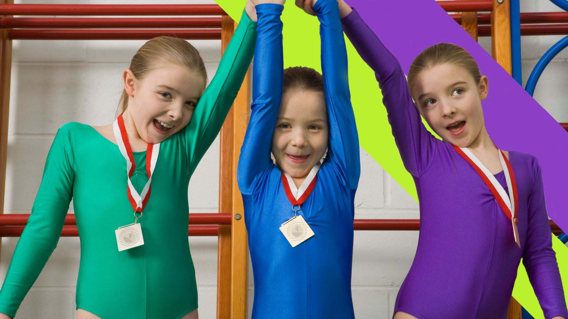 Junior gymnasts, in front of our Edge Hill Sport double sash branding