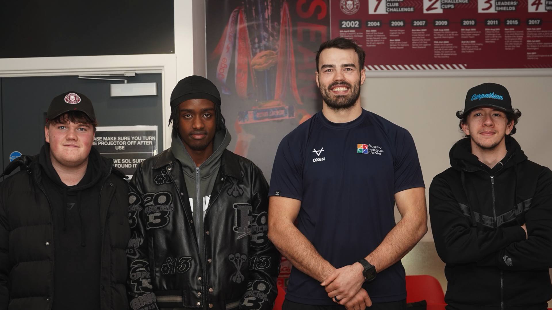 4 men looking into the camera standing side by side.