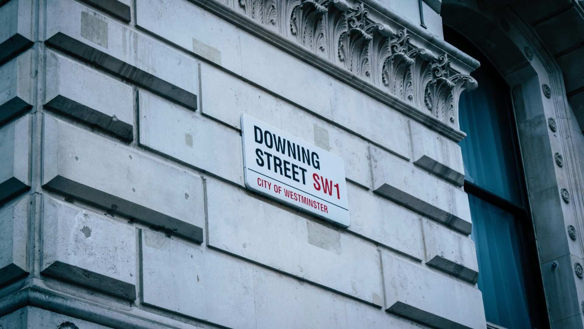 a brick wall with downing street road on it.
