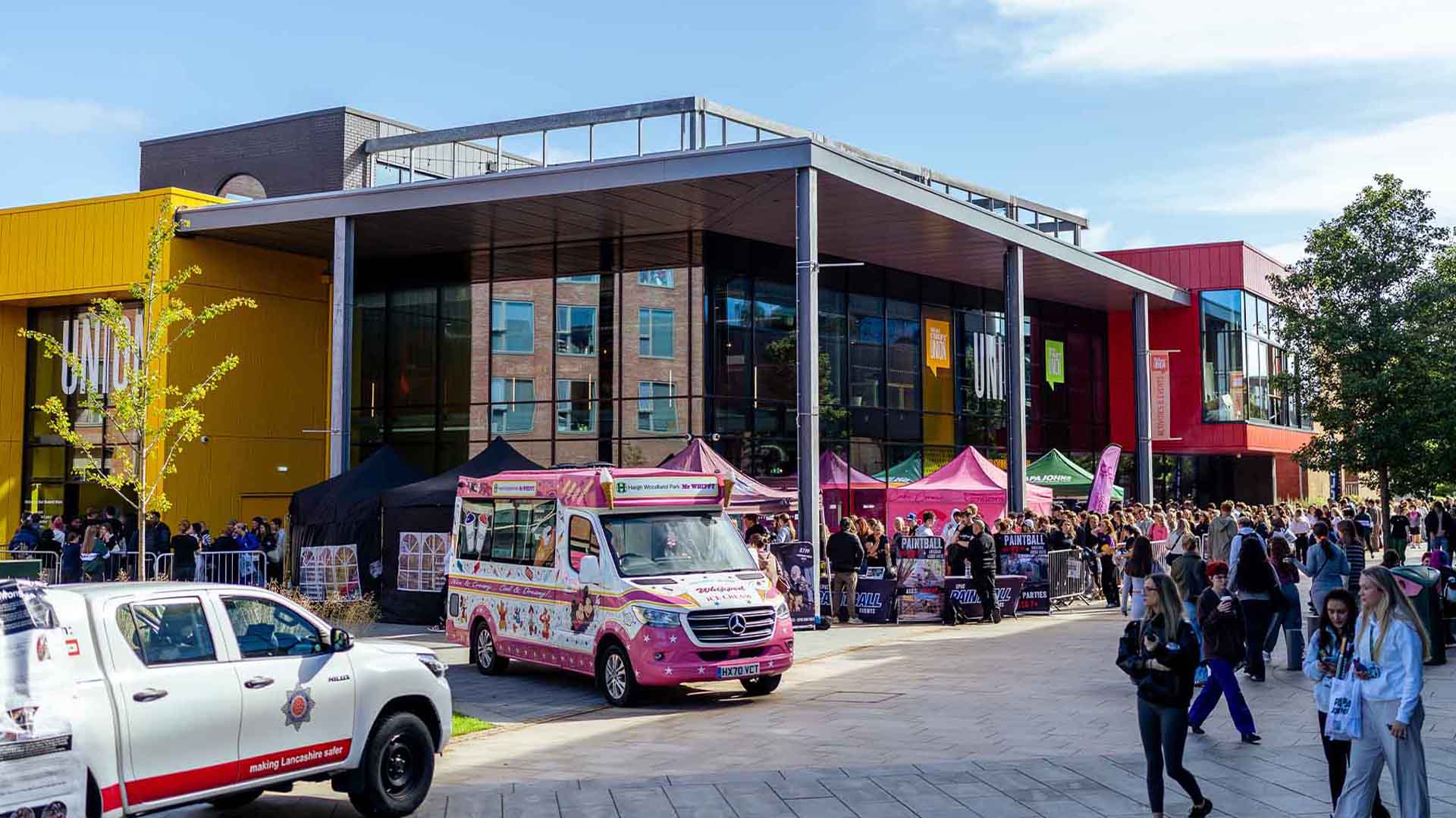 Students engaging with local businesses and organisations during Welcome Week outside our Students' Union building.
