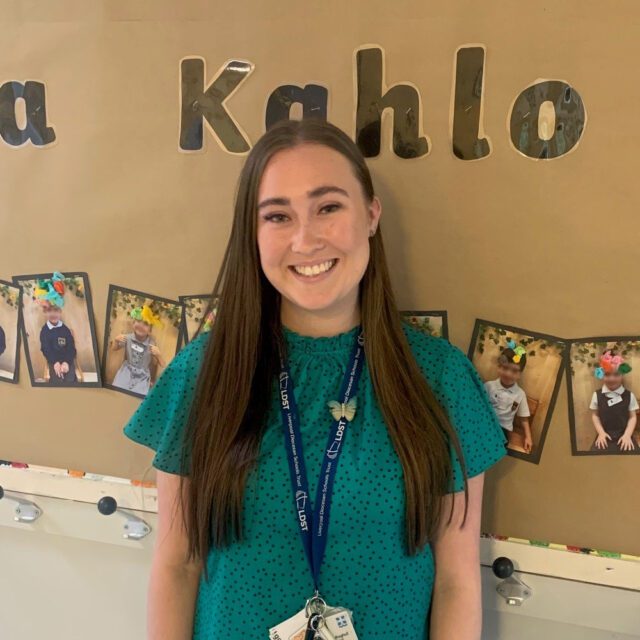 Lydia Wakeham stood in front of a wall display at her placement school