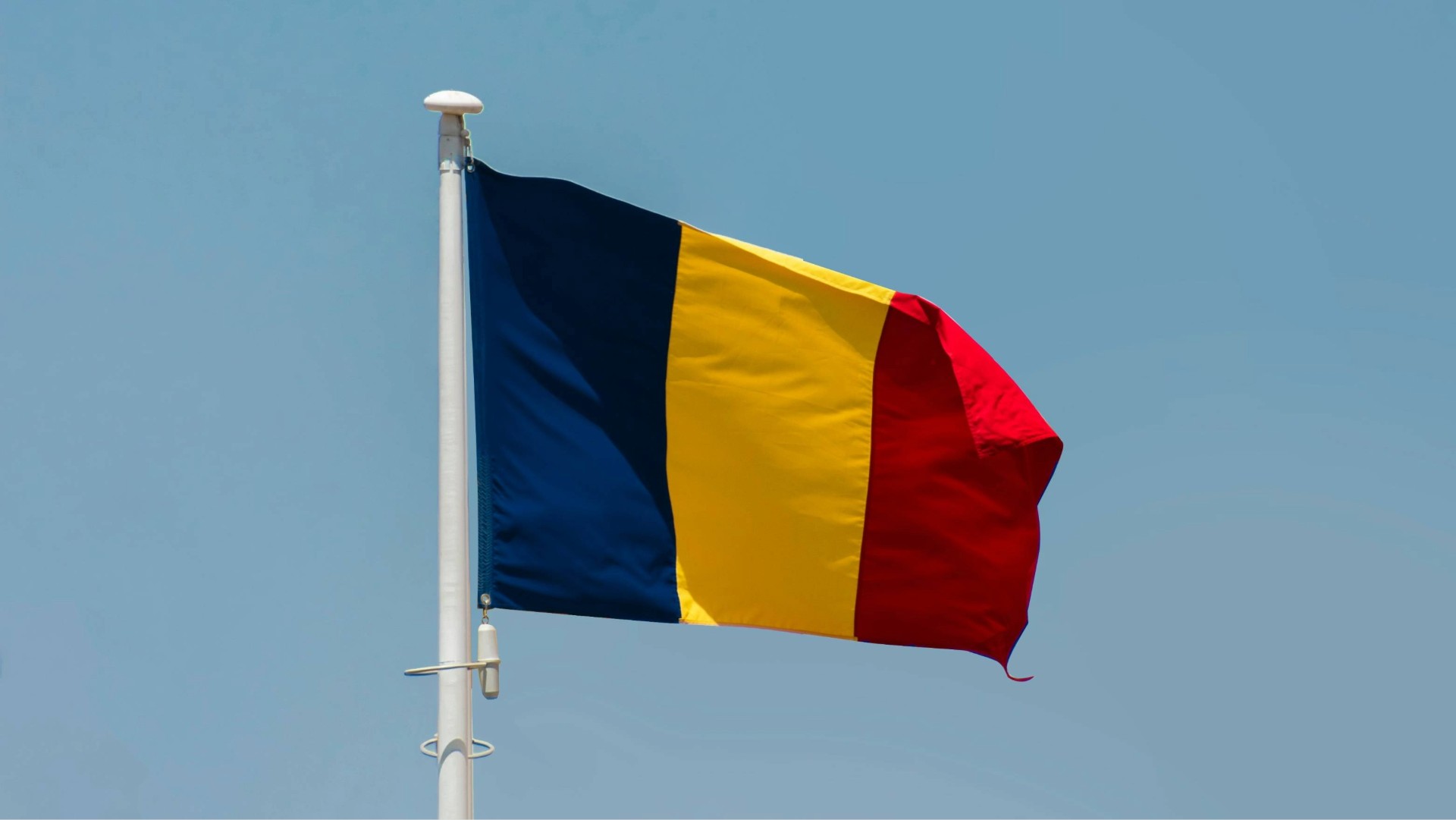 A Romanian flag on a pole