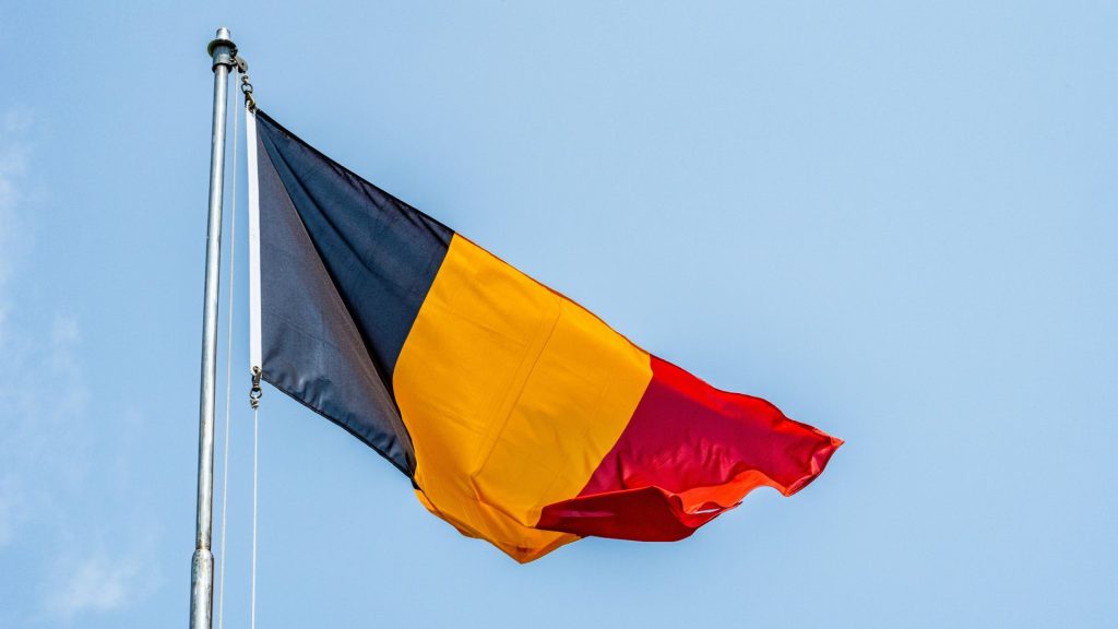 a Romanian flag flying on a pole.